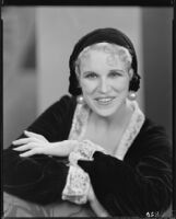 Peggy Hamilton modeling a velvet hat and a long dress of chiffon velvet and Alençon lace, 1930