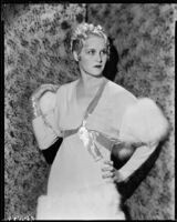 Peggy Hamilton modeling a chiffon gown with empire waist and fur trim, 1933