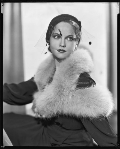 Actress (?) modeling a fur-trimmed dress, circa 1931-1933