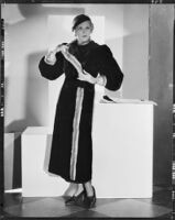 Peggy Hamilton modeling a sealskin coat trimmed in ermine, 1933