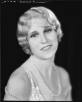 Peggy Hamilton modeling a hairstyle and dance frock decorated with bugle beads and rhinestones, 1930