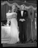 Peggy Hamilton, wearing a currency-themed gown, with James Francis Thaddeus O'Connor, Comptroller of the Currency, at Grauman's Theater, Los Angeles, 1932