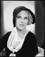 Peggy Hamilton modeling a hat of black soleil with hemstitched border and felt rose petals, 1930