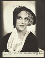 Peggy Hamilton modeling a hat of black soleil with hemstitched border and felt rose petals, 1930