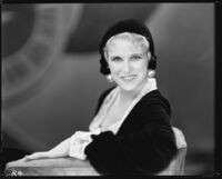 Peggy Hamilton modeling a velvet hat and long dress of chiffon velvet and Alençon lace, 1930