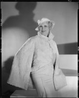 Peggy Hamilton modeling a white caracul cape and frosted crepe wool hat, 1933