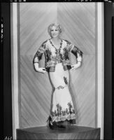 Peggy Hamilton modeling a white chiffon gown with black hand-appliqued lace, 1931