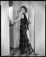 Actress Natalie Kingston modeling a beaded evening gown, circa 1930