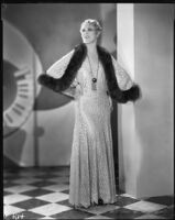 Peggy Hamilton modeling a long lace dress from Jean Swartz's Fashion Salons, 1930