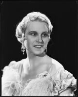 Peggy Hamilton modeling a hairstyle and evening gown, circa 1933