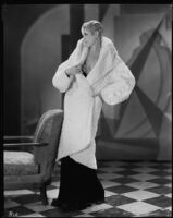 Peggy Hamilton modeling a white ermine coat, 1930