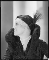 Peggy Hamilton modeling a Hortense hat and a coat with a high collar and flared cuffs, 1931