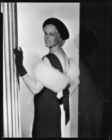 Peggy Hamilton modeling a black velvet hat and dinner gown, 1933