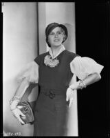 Peggy Hamilton modeling a fitted dress, a hat and embroidered gloves, circa 1931-1933