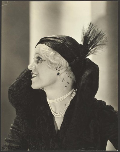 Peggy Hamilton modeling a Hortense hat and a coat with a high collar and flared cuffs, 1931