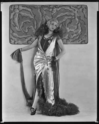 Peggy Hamilton modeling a lamé evening gown and metallic wig, circa 1925