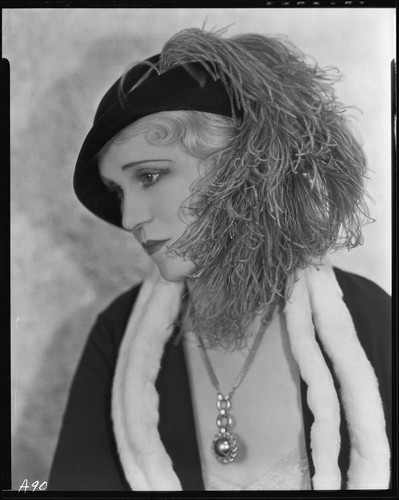 Peggy Hamilton modeling a dress or coat with light fur trim and a hat trimmed with an ostrich feather, circa 1931