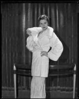 Actress Gail Patrick modeling a white Russian ermine coat, 1932