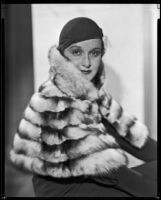 Actress Gail Patrick modeling a fur stole, circa 1932-1933