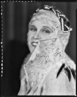 Peggy Hamilton modeling a headband with braided pearls, 1931