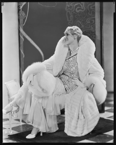 Peggy Hamilton modeling an ermine coat and chiffon evening gown, 1931