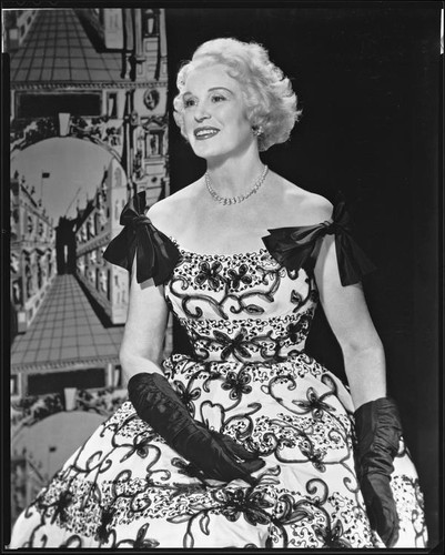 Peggy Hamilton modeling a dress with floral embroidery, 1933