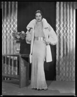 Actress Gail Patrick modeling a white Russian ermine coat, 1933