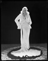 Peggy Hamilton modeling a Dolly Tree gown of chiffon velvet and a white ermine jacket, 1931