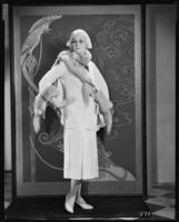 Peggy Hamilton modeling a cape of her own design of cream corded henrietta cloth, 1931