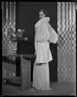 Actress Gail Patrick modeling a white Russian ermine coat, 1933