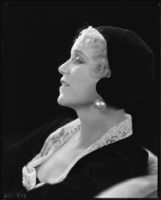 Peggy Hamilton modeling a velvet hat and a long dress of chiffon velvet and Alençon lace, 1930