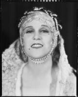 Peggy Hamilton modeling a headband with braided pearls, 1931