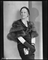 Peggy Hamilton modeling a [velveteen?] dress, fur stole and hat, 1931