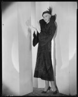 Peggy Hamilton modeling a Hortense hat and a coat with a high collar and flared cuffs, 1931