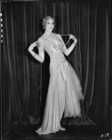 Peggy Hamilton modeling a dance frock decorated with bugle beads and rhinestones, 1930