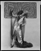 Peggy Hamilton modeling a lamé evening gown and metallic wig, circa 1925