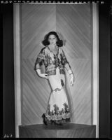 Peggy Hamilton modeling a white chiffon gown with black hand-appliqued lace, 1931