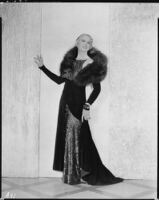 Peggy Hamilton modeling an Earl Luck velvet coat and blue sequin dinner gown, 1931