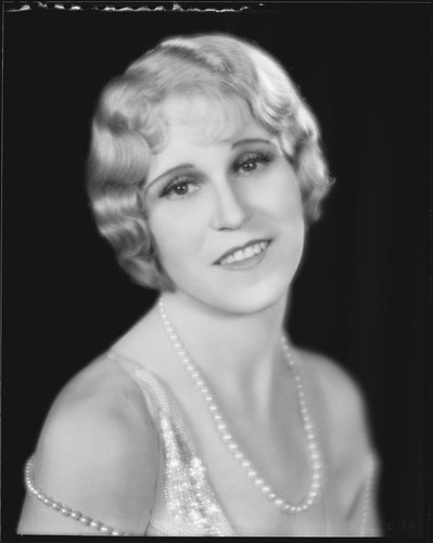 Peggy Hamilton modeling a hairstyle and dance frock decorated with bugle beads and rhinestones, 1930