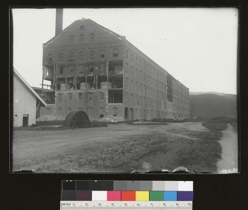 Sugar Mill. Steel buckled on side on building, bricks removed afterwards