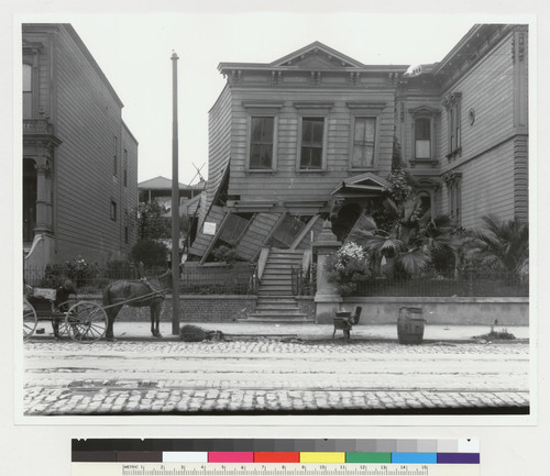 Howard Street [later South Van Ness Street] just south of 21st Street. [Damaged wood frame house, with stove in street.]