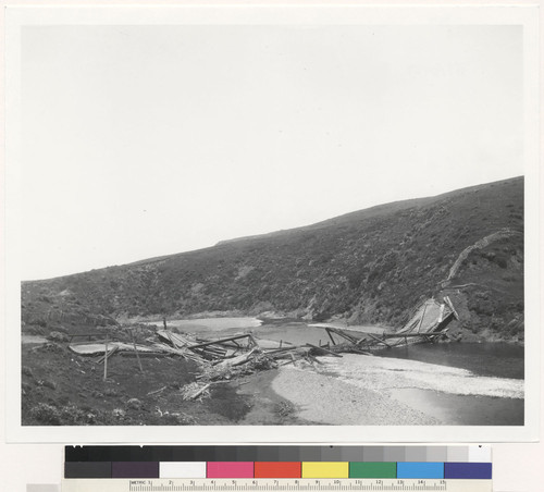 Wrecked bridge over Alder Creek. Fault runs through stream bed under bridge near its south (left) end. F