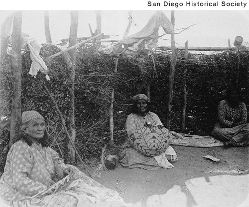 Two Indian women weaving baskets