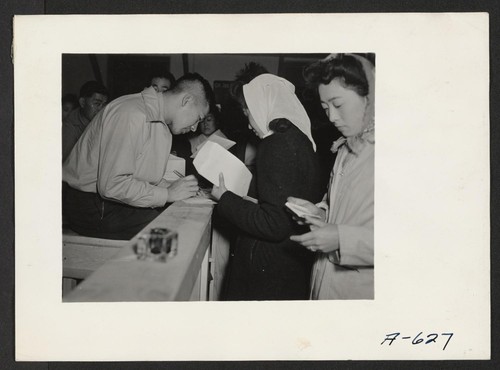Absentee voters of Japanese descent getting ballots and having them notarized. Photographer: Stewart, Francis Newell, California