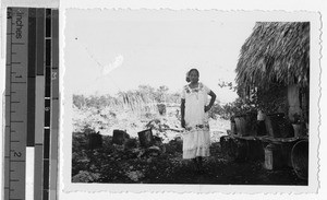 Maya woman standing next to a house, Quintana Roo, Mexico, ca. 1948