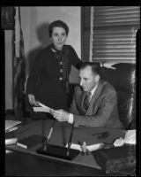 District Attorney Buron Fitts and his sister/secretary Mrs. Berthal Gregory looking at letters, Los Angeles, 1928-1939