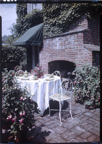[Unidentified outdoor living spaces and sun rooms]. Table and barbecue