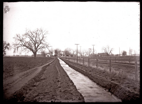 Irrigation ditch with Morehead House in background