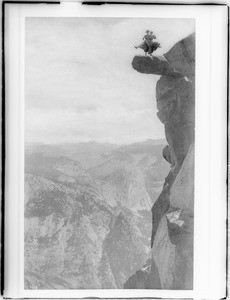 Two women doing a "skirt dance" on the precarious Glacier Point in Yosemite National Park, 1900-1902