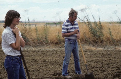 Sue Sim (Staff Research Associate) & Bob Montgomery (worked for agricultural chemicals company) in tomato corky root plot (testing soil solarization)